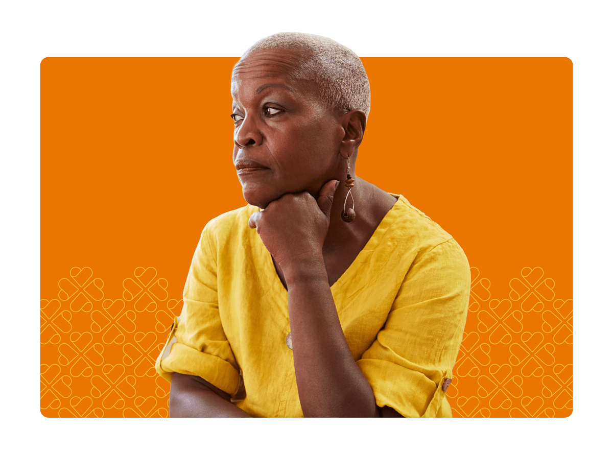 Elderly woman with yellow shirt contemplating