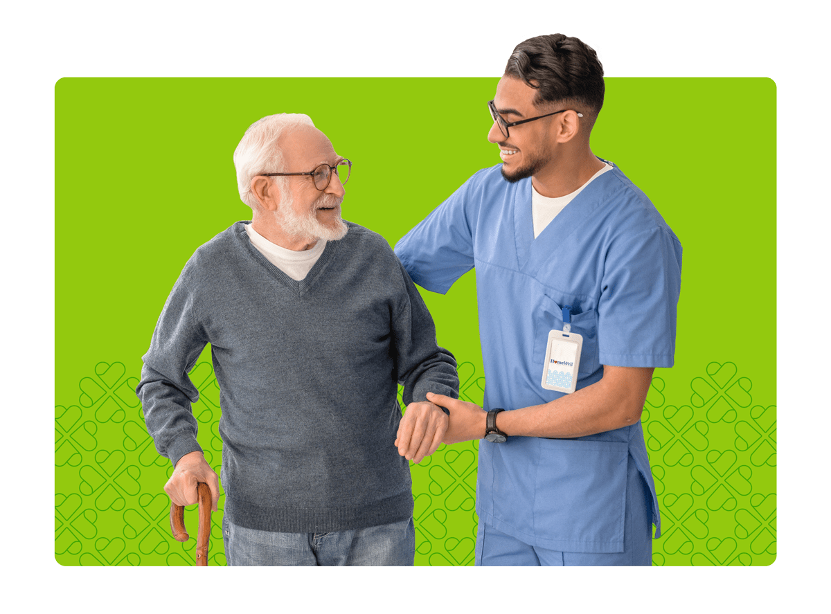 Male Caregiver helping elderly man with cane